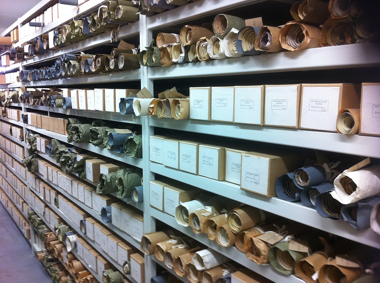 Archive shelves packed with labelled case files and boxed records for cold-case re-examination