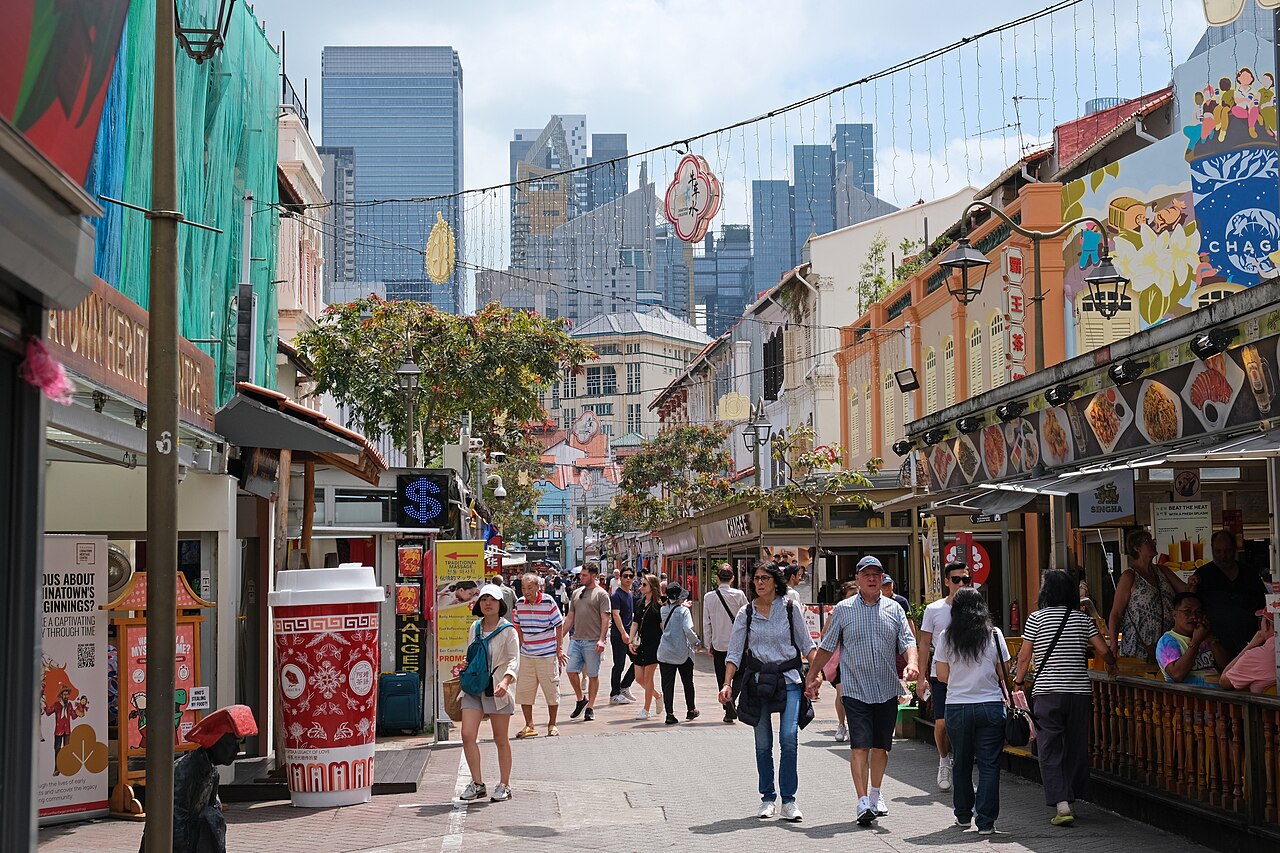Singapore Chinatown street with shophouses and CBD towers — typical field-investigation urban texture