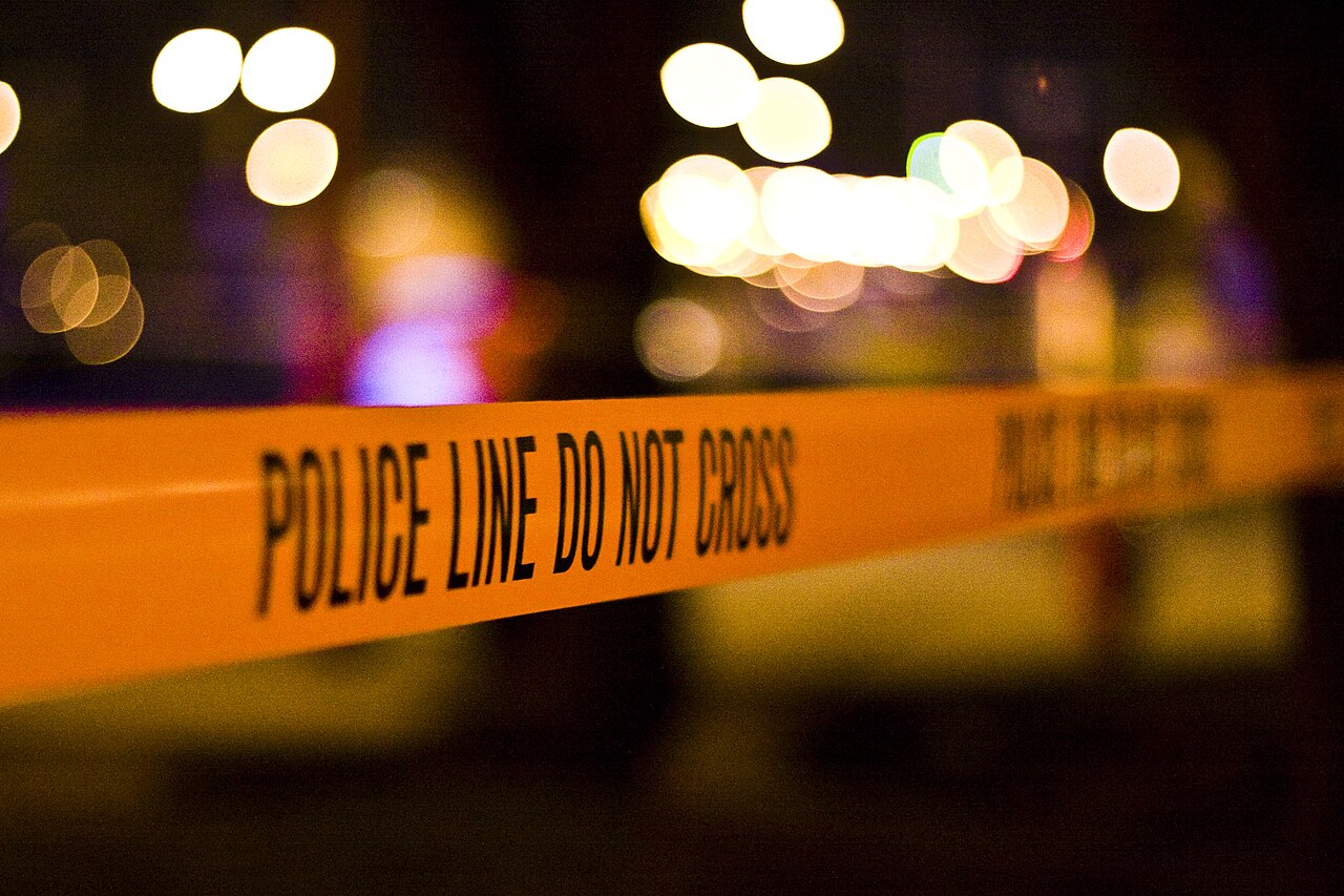Police line tape at a night-time crime scene — the investigative starting point of Inside Crime Scene