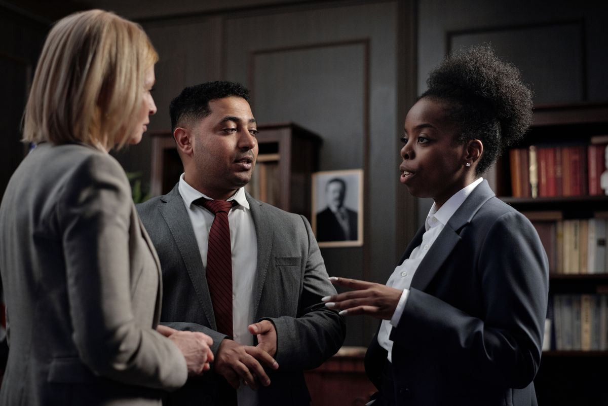 Investigators and specialists in discussion — the inter-agency coordination that drives later episodes