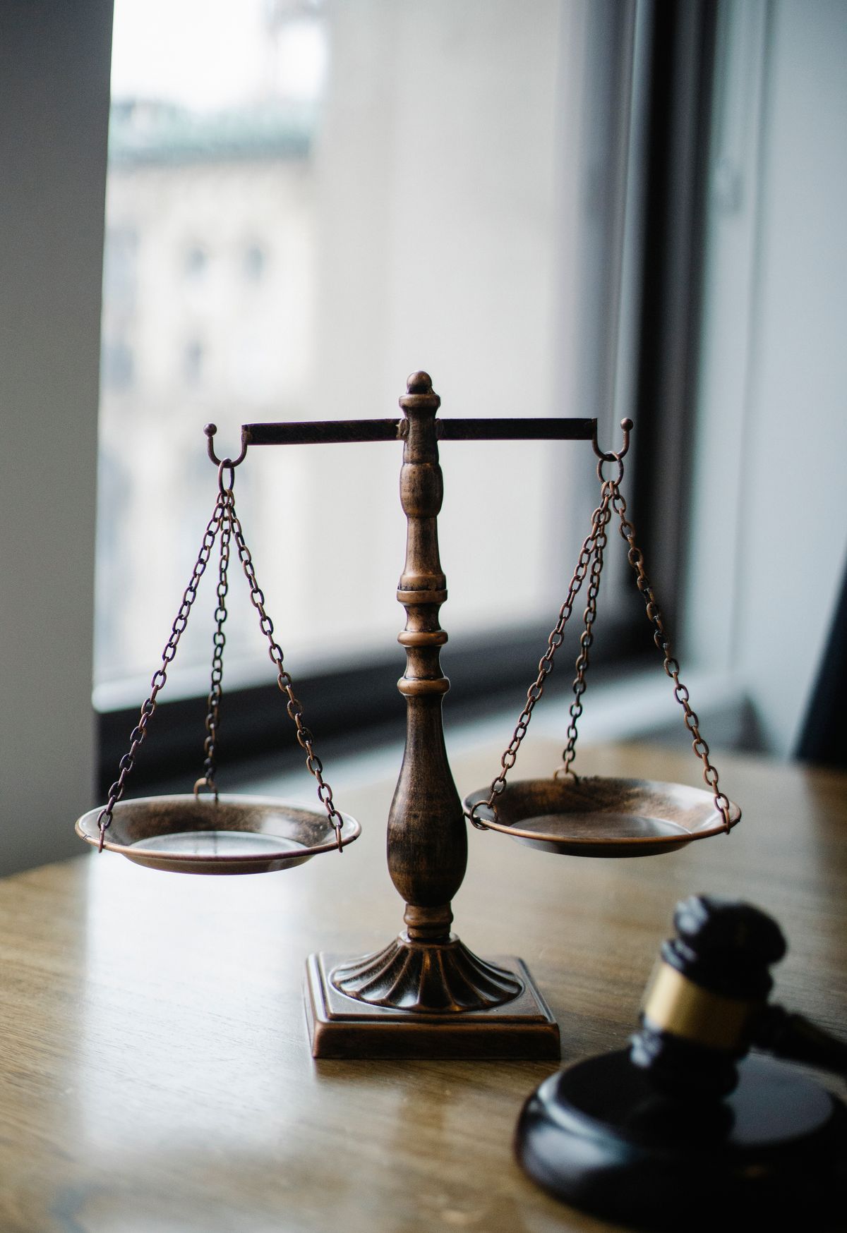 Scales of justice and a judge's gavel used in courtroom commentary