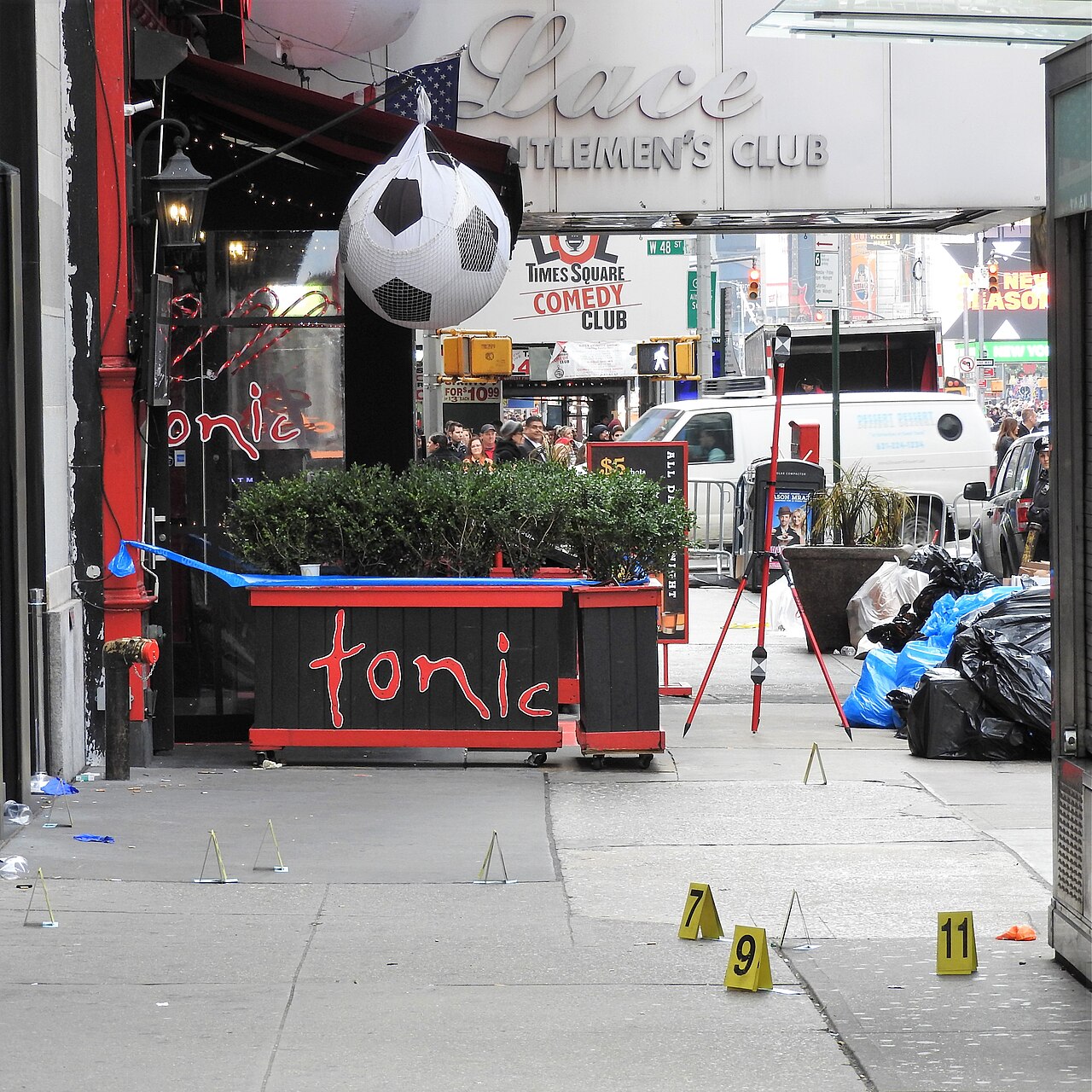 Numbered evidence markers on a sidewalk during a field investigation